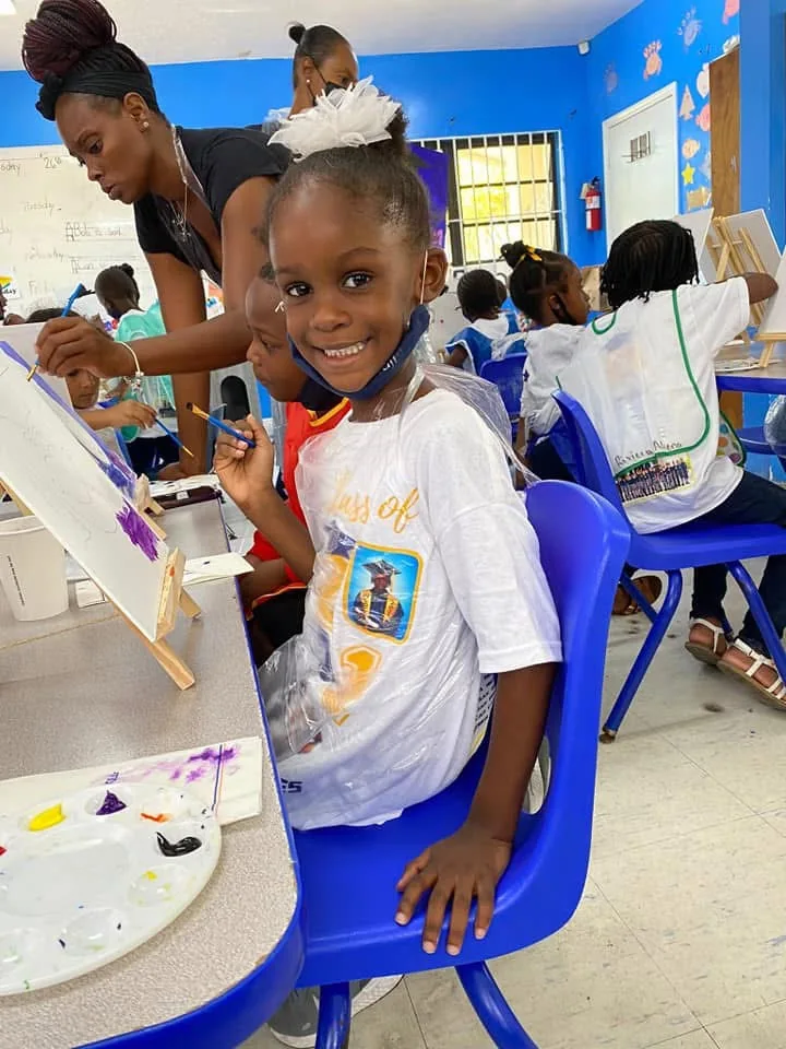 Student painting at an easel during an art activity